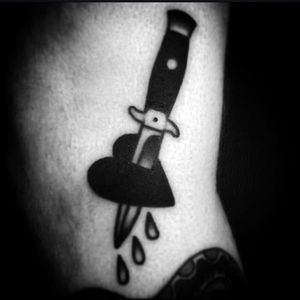 The classic combination of blade and dagger. Awesome work by Kyle Lifetime. #KyleLifetime #blacktattoos #traditionaltattoo #knife #heart #traditional #blackwork