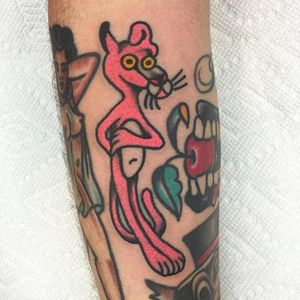 Solid and funky looking pink panther tattoo done by Jason Ochoa. #JasonOchoa #GreenPointTattooCo #traditionaltattoo #boldtattoos #pinkpanther #pink
