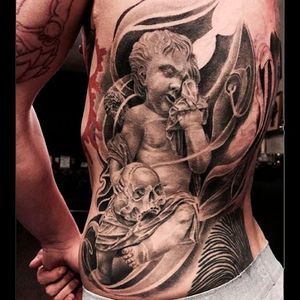 Stunning ribcage piece of a weeping cherub and skull tattoo Photo from Luc Suter on Instagram #LucSuter #BlackDiamondTattoo #LosAngeles #blackworker #fineline #realistic #skull #cherub