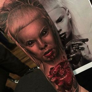 Brutal looking lady vamp eating a human heart. Intense tattoo by Fredy Tomas. #FredyTomas #ExoticTattoo #realistictattoo #vampire #heart