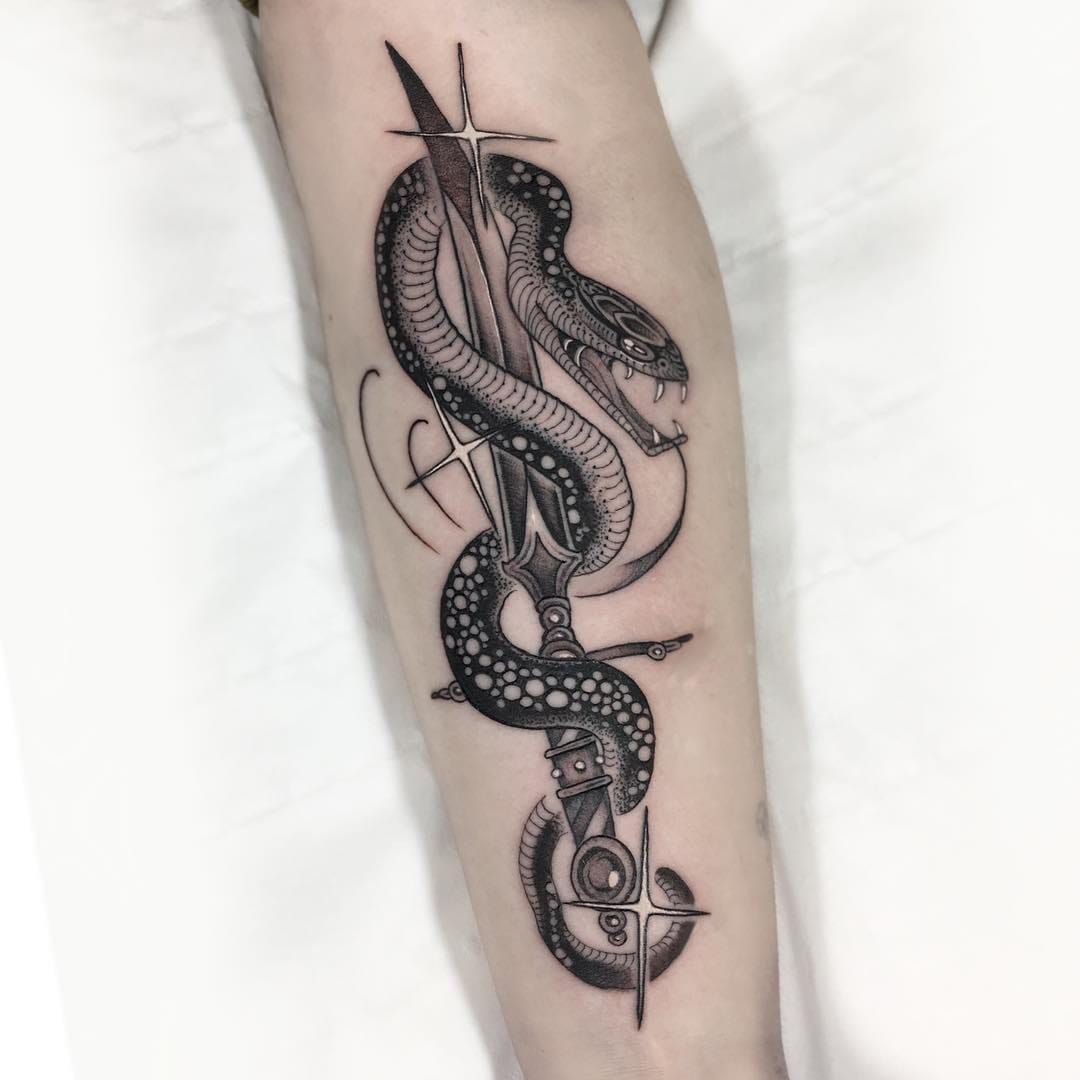 Tattoo uploaded by Tattoodo • Snake and sword tattoo by Gabriele Cardosi  #GabrieleCardosi #whiteinktattoos #blackandgrey #snake #reptile #fangs # sword #knife #star #oldschool #neotraditional #mashup #tattoooftheday •  Tattoodo