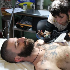 Tattoo artist Leta Gray working on a client. (photo by kd diamond) #ShopProfile #SpiritedTattooingCoalition #WestPhilly #Philly