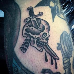 Sword through the skull. Solid little black tattoo done by Simon Erl. #SimonErl #blackwork #traditionaltattoos #blacktattoos #DHARMAtattoo #sword #skull
