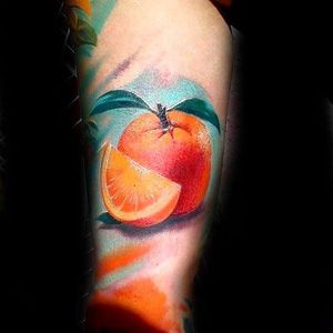 Color realism orange tattoo with a bright blue contrasting background.Tattoo by Robert Florek.  #orange #citrus #fruit #realism #colorrealism #RobertFlorek
