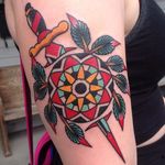 A dagger thrust through a rosette by Mikey Holmes (IG—mikeyholmestattooing). #bold #colorful #American #dagger #MikeyHolmes #rosette #traditional