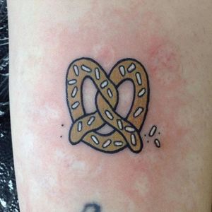 Tiny traditional pretzel tattoo by James Monterio. #traditional #tiny #pretzel #food #JamesMonterio