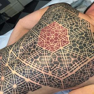 Bold dotwork back-piece with red ink center by Mould. #backpiece #geometric #NathanMould #ornamental #stippled #dotwork