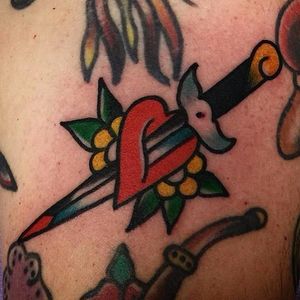 Dagger through the heart. Simple yet solid tattoo done by Aldo Rodriguez. #AldoRodriguez #GrandUnionTattoo #traditionaltattoo #boldtattoos #dagger #heart