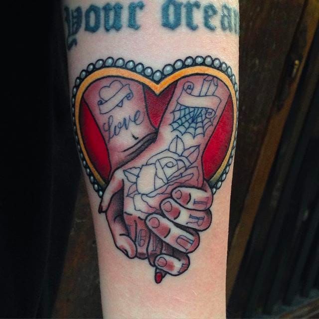 Hand Holding Heart Traditional Tattoo