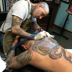 A photography of Heinz working on a back-piece for one of his clients (IG—heinztattooer). #bangers #bold #bright #Heinz #oldschool #traditional