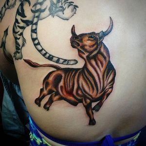 Graceful bull fighting tattoo by La Sirena at Calaveras Custom Tattoos #LaSirena #bulltattoo