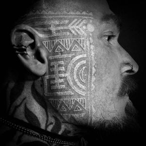 White ink tribal tattoo by Watsun Atkinsun #WatsunAtkinsun #whiteinktattoos #facetattoo #tribal #geometric #linework #shapes #triangle #moon #dotwork #dots #circle #ornamental #tattoooftheday