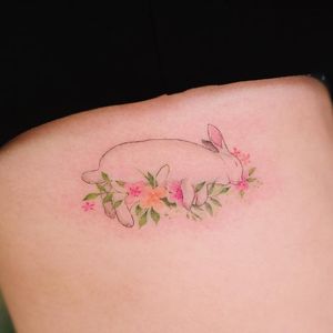 Sleeping bunny and flower tattoo by Sol Tattoo #SolTattoo #flowertattoos #fineline #minimal #small #watercolor #realism #realistic #bunny #rabbit #sleeping #flowers #leaves #nature #cute #tattoooftheday