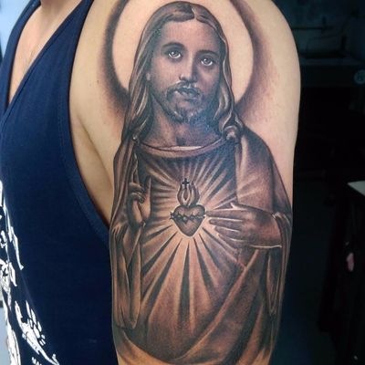 Sacred Heart Jesus by Tommy Montoya #TommyMontoya #blackandgrey #realism #realistic #Jesus #religious #sacredheart #heart #cross #halo #holy #fire #light #tattoooftheday