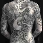 Dragon versus Tiger tattoo by Chris Garver #ChrisGarver #Japanesetattoos #blackandgrey #dragon #tiger #junglecat #scales #fire #lightning #clouds #fight #battle #warrior #tattoooftheday