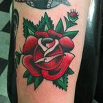 Clean and vibrant classic red rose tattoo by Janitor Jake. #JanitorJake #HatCityTattoo #traditional #boldtattoos #rose #redrose