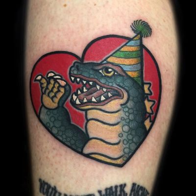 Godzilla Birthday tattoo by Ash Hochman #AshHochman #color #newtraditional #traditional #mashup #heart #valentine #godzilla #dinosaur #birthday #hat #tattoooftheday
