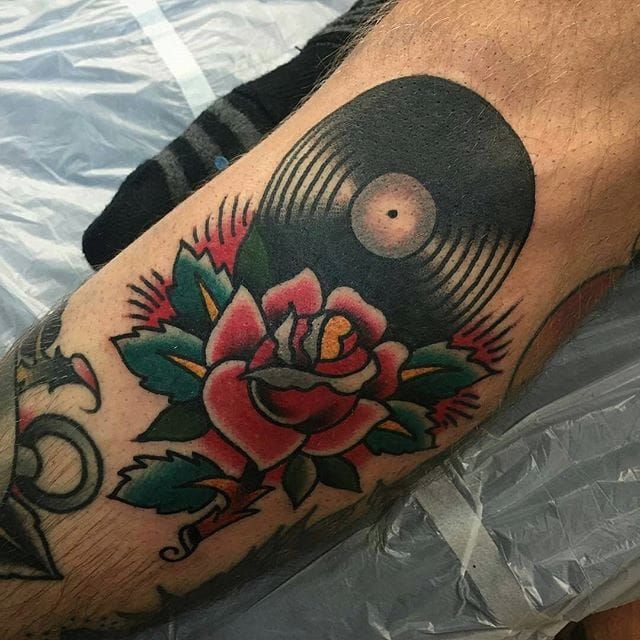 Vinyl record tattoo on the inner forearm