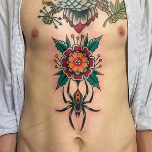Solid and clean spider and flower stomach tattoo. Amazing work by Nick Mayes. #NickMayes #NorthSeaTattoo #traditionaltattoo #classictattoos #spider #flower