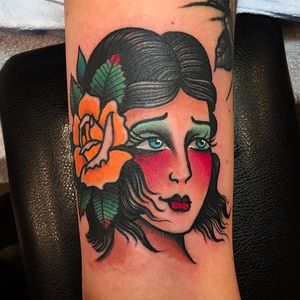 Clean and vibrant traditional girl head tattoo by Paul Nycz. #PaulNycz #traditional #neotraditionaltattoo #coloredtattoo #rose #girlhead