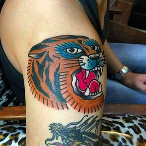 Bold and solid tiger head tattoo done by Wilson Ng. #WilsonNg #BoldTattoos #traditionaltattoo #tiger #coloredtattoo #color #traditional #tigerhead