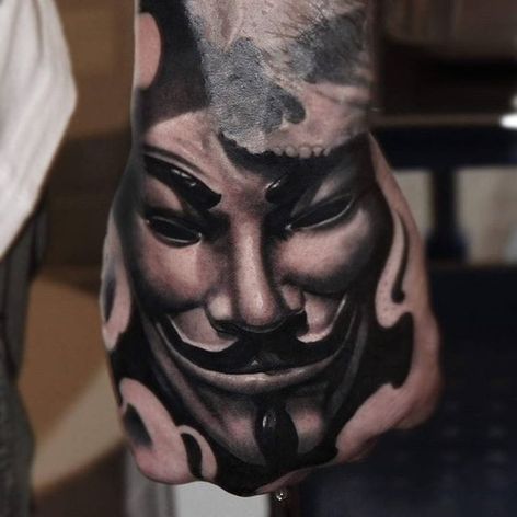 Tatuaje de la mano de la máscara de Guy Fawke por Mads Thill.  #tatuaje en la mano #blackandgrey #anónimo #guyfawkesmask #MadsThill