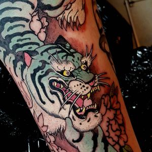 Blue tiger tattoo by Elliott Wells #ElliottWells #cattattoos #tiger #color #japanese #neotraditional #mashup #irezumi #junglecat #fangs #peony #claws #nature