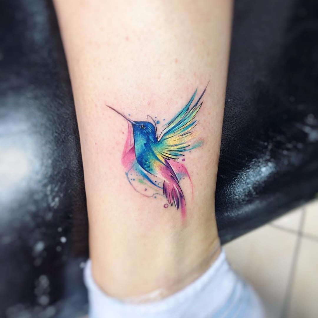 Small watercolor style hummingbird tattoo