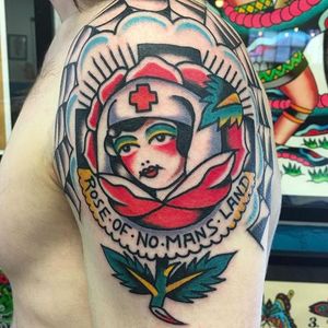 Rose of no mans land. Clean and solid work by Fergus Simms. #FergusSimms #MelbourneTattooCompany #traditionaltattoo #boldtattoos #rose #nurse #roseofnomansland