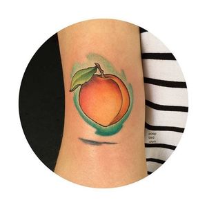 Simple peach tattoo with a contrasting watercolor background. By Mike Groves. #peach #fruit #watercolor #neotraditional #MikeGroves