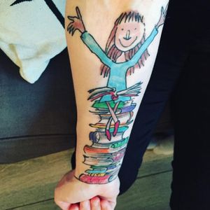 A tattoo of Matilda on a pile of books by an unknown artist. #childrensliterature #Matilda #RoaldDahl #QuentinBlake