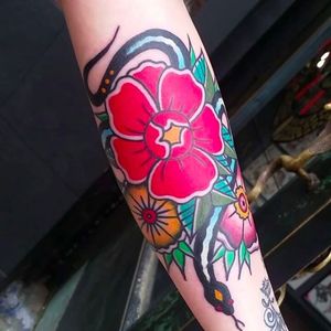 Bold and solid rose and blossoms tattoo done by Douglas grady. #DouglasGrady #traditionaltattoo #coloredtattoo #brightandbold #rose #blossoms