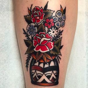Flowers in a vase. Awesome tattoo by Jacob N. #JacobN #traditionaltattoo #boldtattoo #oldschool #flowers #floral #traditional