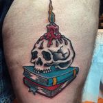 A skull with a candle melted to its cranium by Andy Perez (IG—andyjperez). #AndyPerez #AlliedTattoo #books #candle #NYCtattooshops #skull #traditional