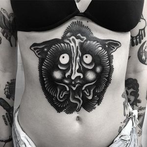 A badass stomach tattoo of a silly monster by Simone Ruco (IG— ruco__). #blackwork #illustrative #masks #monsters #SimoneRuco