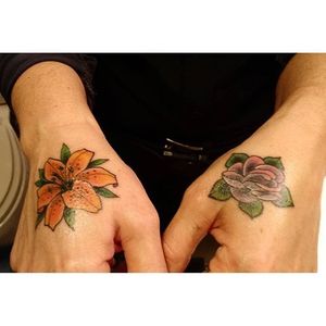Tiny tiger lily hand tattoo by @aelliott2. #tigerlily #flower #traditional #hand #aelliott2