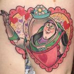 Buzz Lightyear getting in touch with his feminine side. Tattoo by Jackie Huertas. #traditional #JackieHuertas #Disney #Pixar #ToyStory #BuzzLightyear #pastel