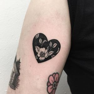 Flower with heart-shaped negative space tattoo by Vlada Shevchenko. #VladaShevchenko #blackwork #feminine #women #floral #flower #negativespace #heart