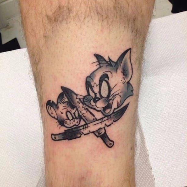 Hand poked Tom and Jerry tattoo on the upper arm