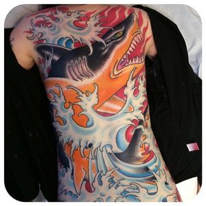 Solid action packed back tattoo of a shark and some waves. Tattoo done by Jason Brooks. #jasonbrooks #GreatWaveTattoo #boldtattoos #TraditionalTattoo #shark #backpiece