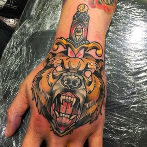Ferocious bear tattoo on hand done at TW Tattoo #TWTattoo #Bear #BearTattoo #Hand #Neotraditional