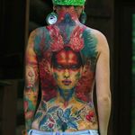 Intense looking back tattoo of a druid done by Nika Samarina. #nikasamarina #coloredtattoo #surrealtattoo #organic #druid #vibrantcolours