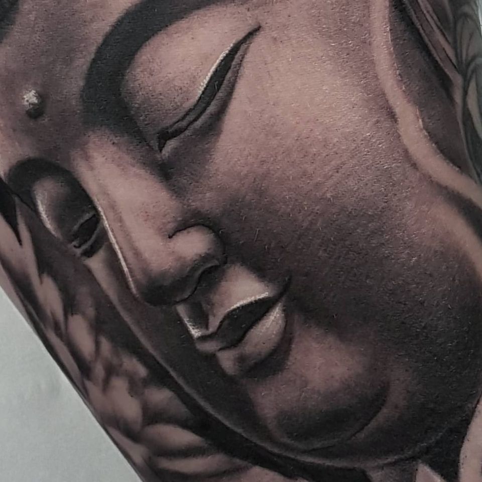 A closeup of one of Ryan Lord's realistic depictions of Buddha (IG—ryanlord_tattoo). #blackandgrey #Buddha #RyanLord