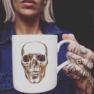 Another sleek and creative design, gold skull coffee cup by Red Temple Prayer, in collaboration with freelance artist _elfin_ #gold #goldskull #skull #coffee #coffeecup #tattooinspiration #fashion #RedTemplePrayer