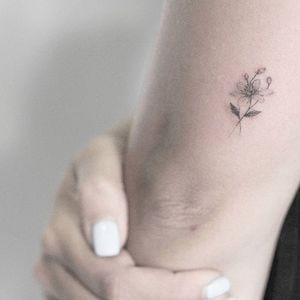 Micro tattoo by Lindsay April. #flower #microtattoo #dotwork #pointillism #subtle #LindsayApril