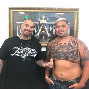 Chris Showstoppr stands next to his beautiful handiwork on the chest of fighter Mark Hunt.