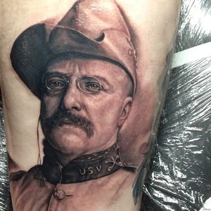 An incredible tattoo of Teddy Roosevelt. Work by Steve Wimmer. #SteveWimmer #portraittattoo #realistic #teddyroosevelt #blackandgrey