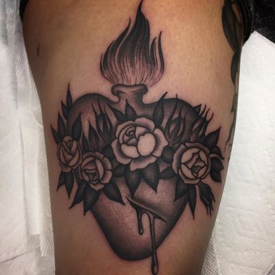 Sacred heart tattoo by Shaun Topper #ShaunTopper #religioustattoo #blackandgrey #traditional #sacredheart #heart #fire #roses #flower #leaves #heart #blood #blooddrop #Christian #Catholic #love #tattoooftheday