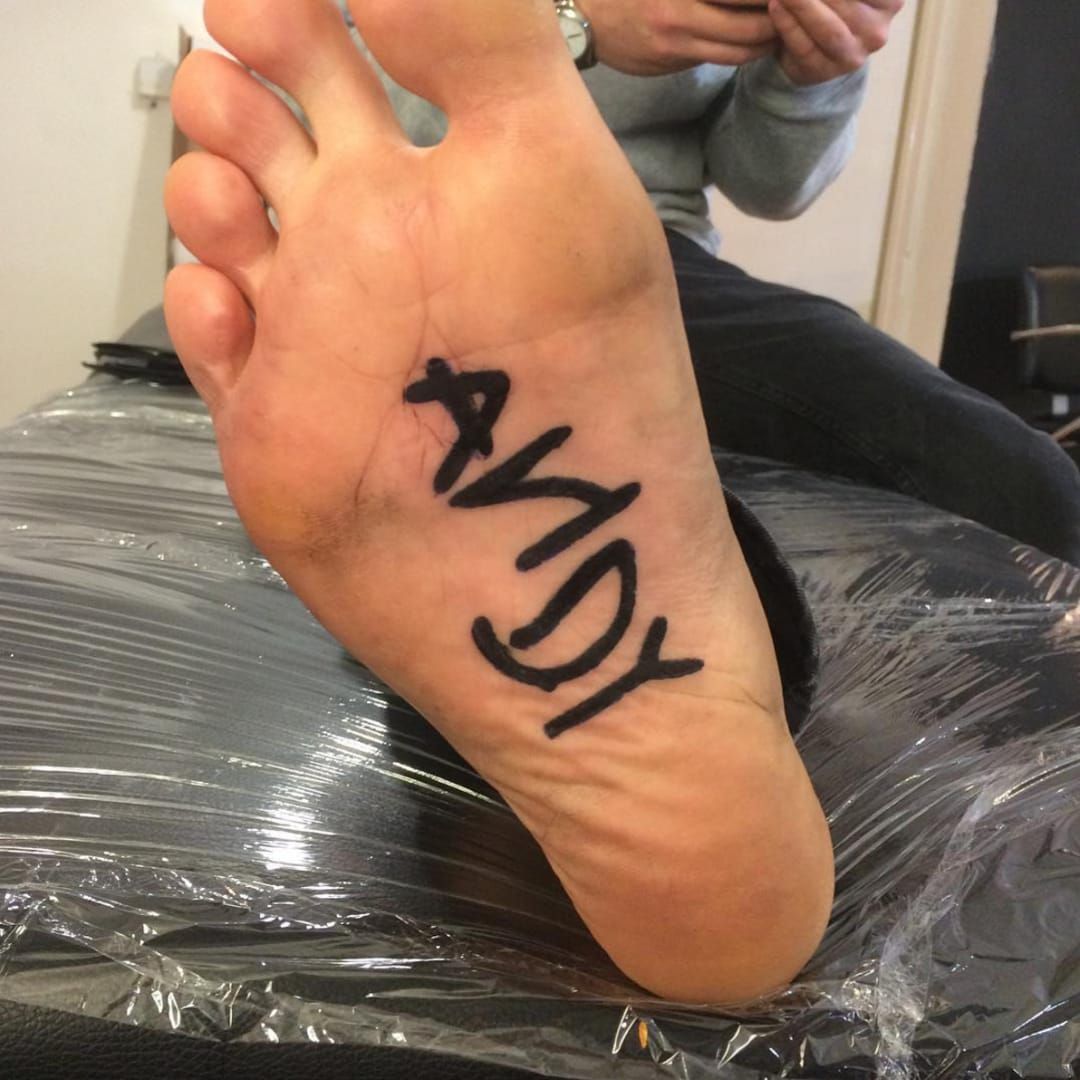 Guy gets painful Andy Toy Story tattoo on foot Is he now one of Andys  toys  YouTube