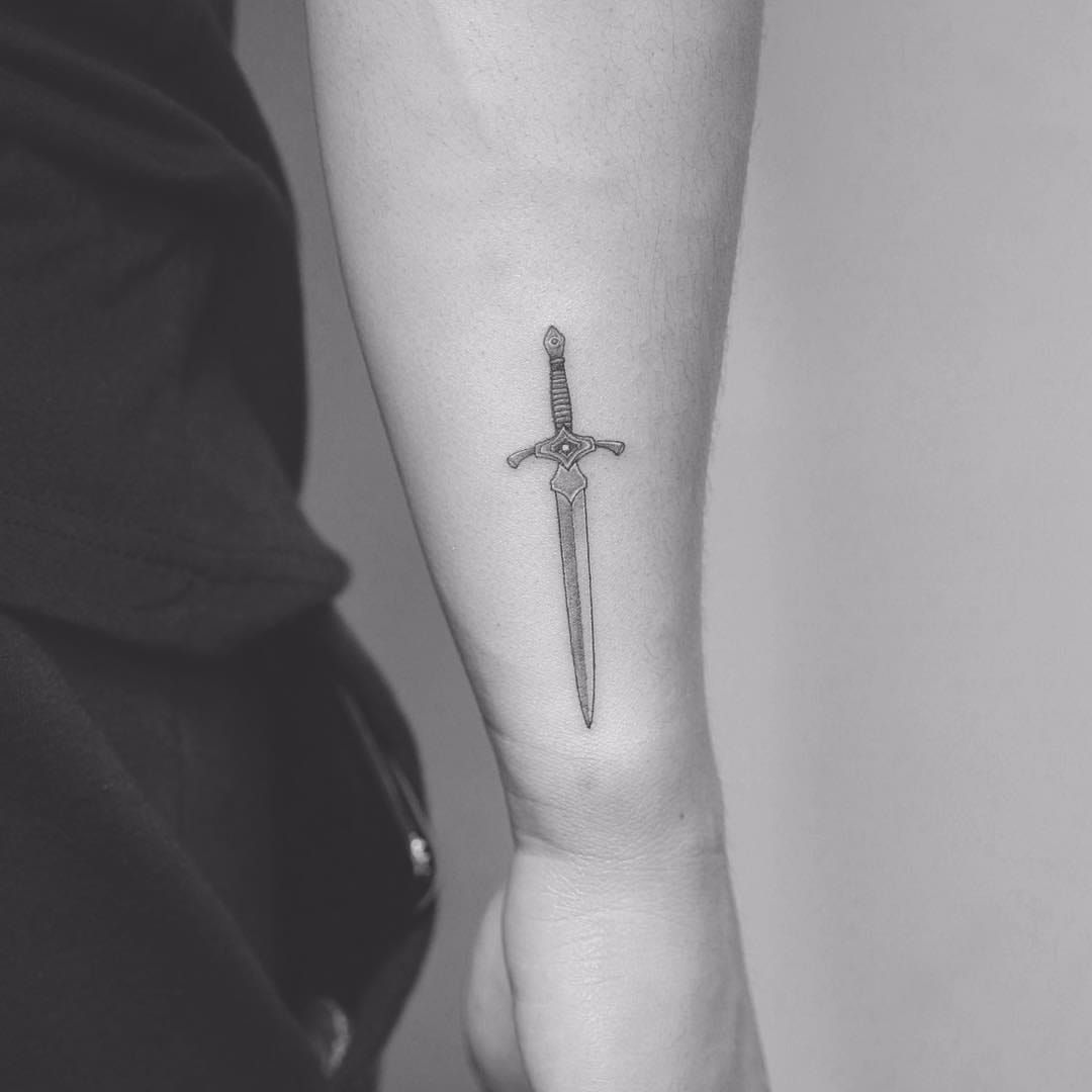 Microrealistic sword tattoo on the forearm